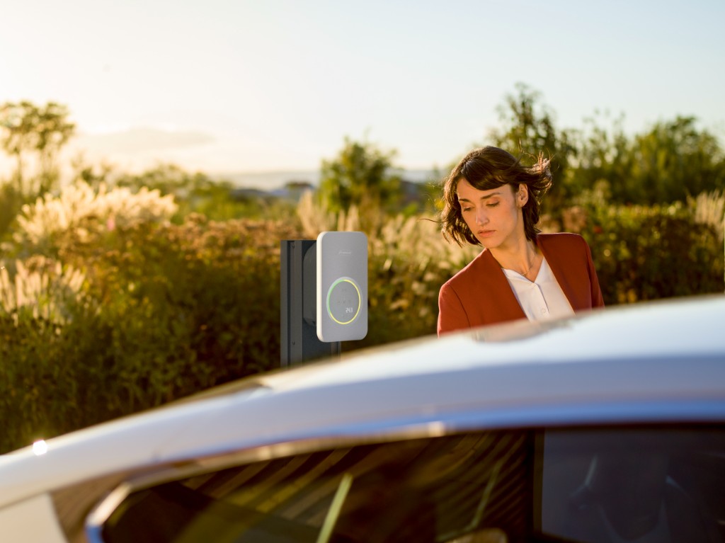 Fronius EV charger lifestyle scene with car and home charging setup